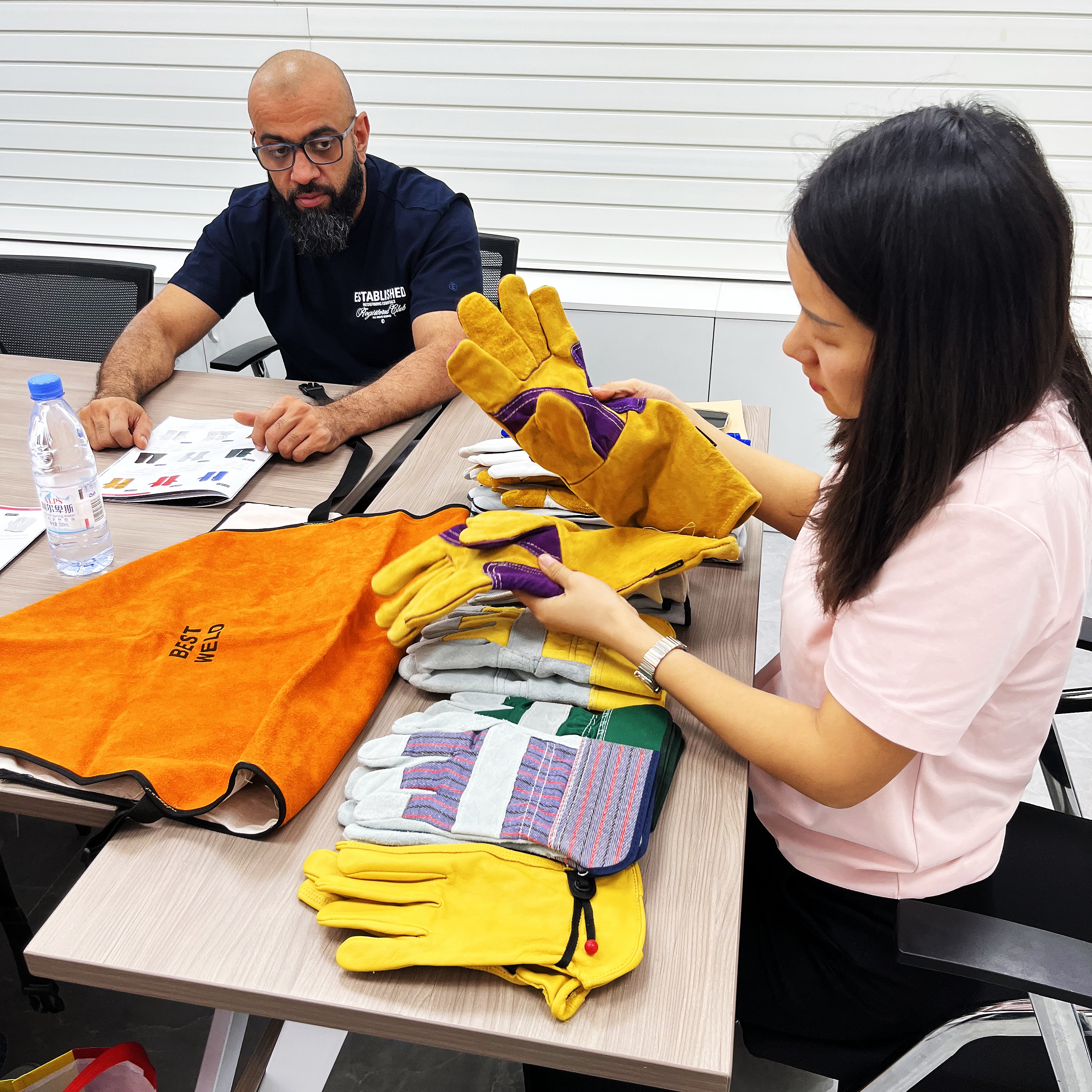 British buyers presenting leather glove samples at Guangzhou Red Sunshine meeting