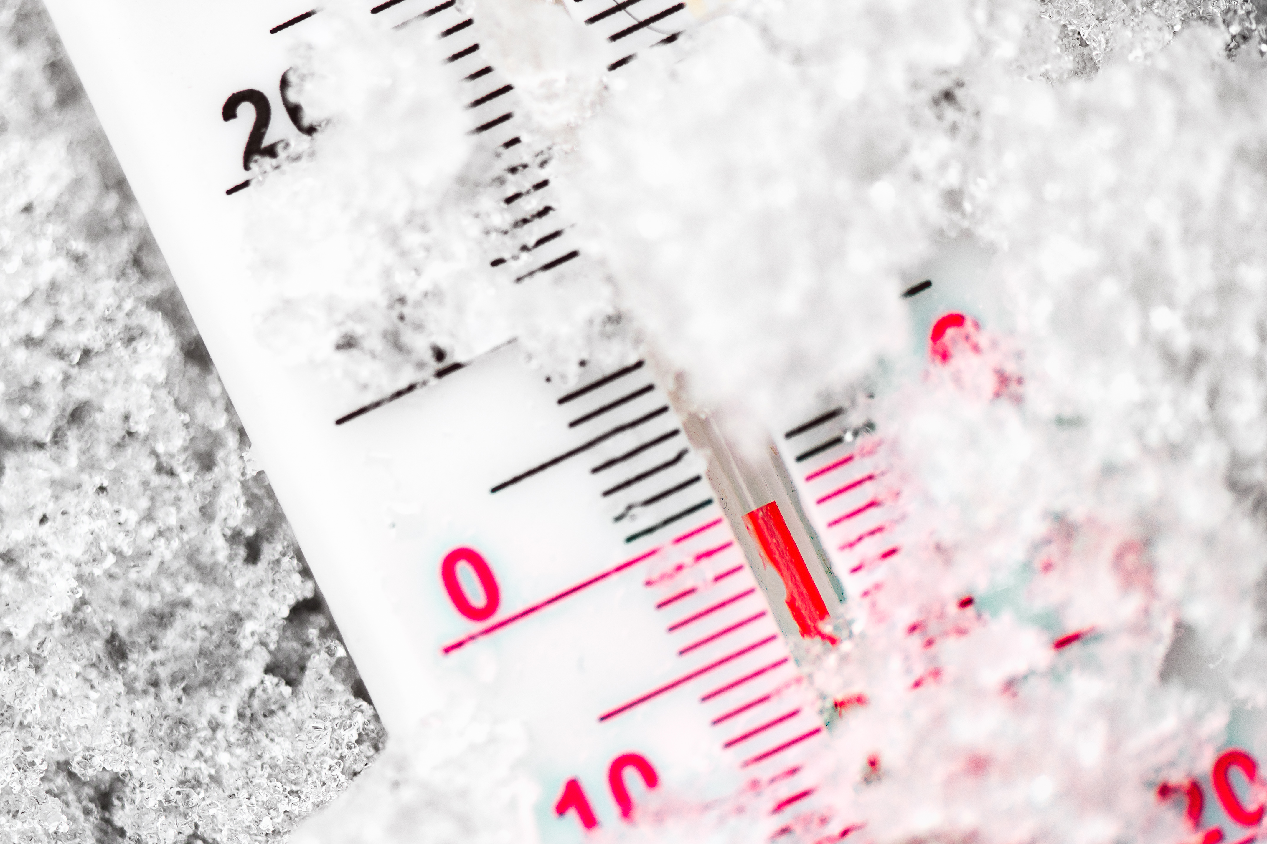 Thermometer marks the zero degrees in the cold in the snow.